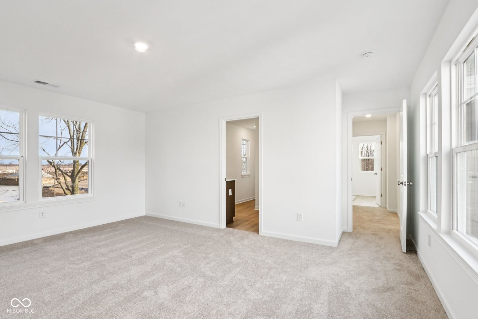 Bright primary suite with abundant natural light and windows.