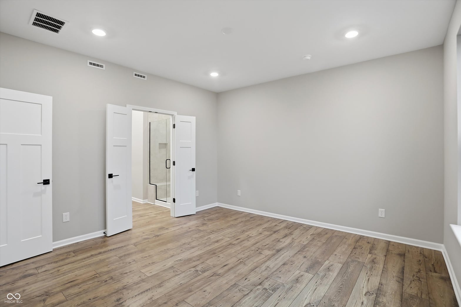 Spacious primary bedroom with luxurious ensuite bathroom.