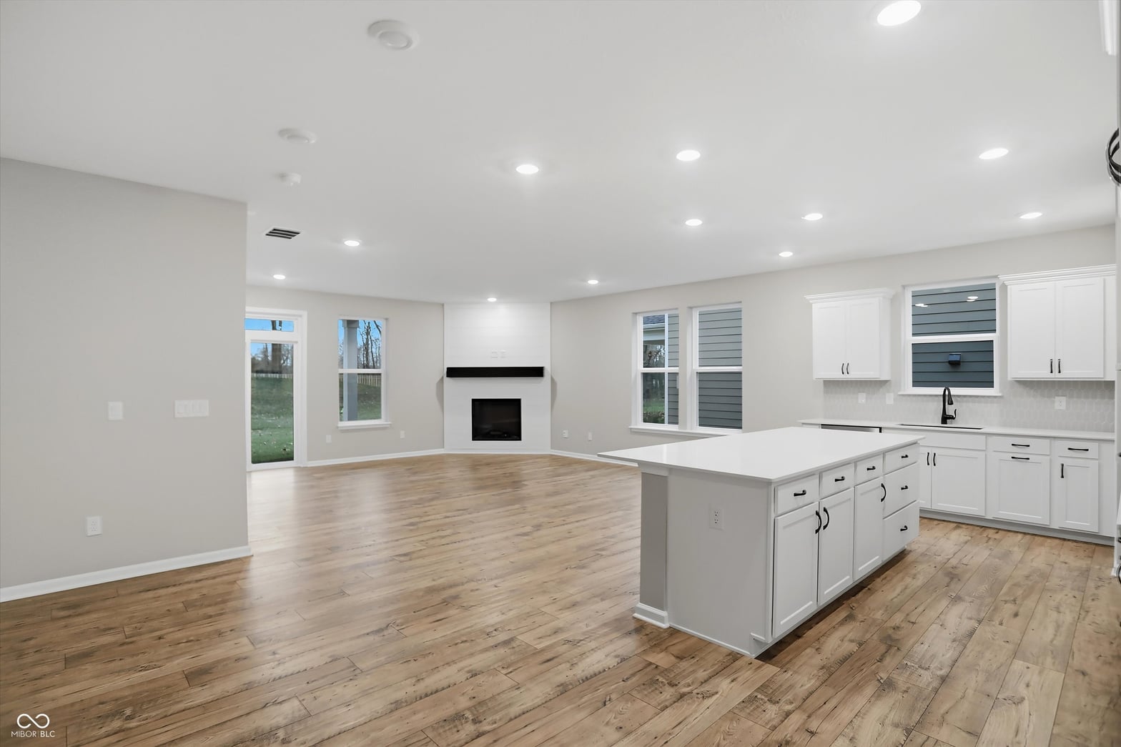 Bright, spacious kitchen with island and fireplace.