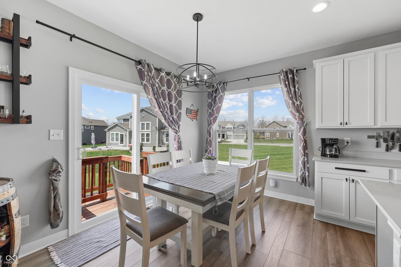 Bright dining space with French doors and neighborhood views.