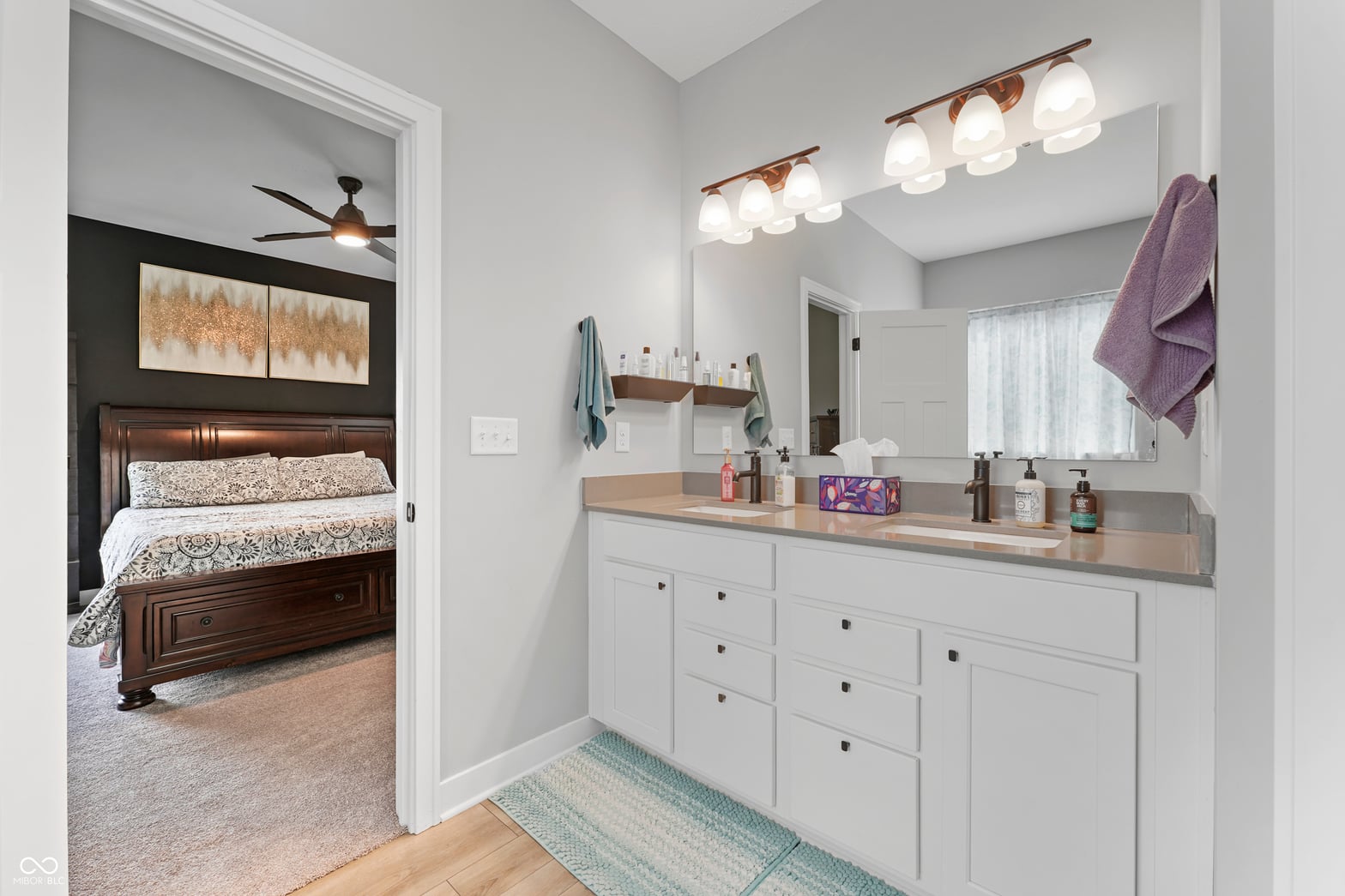 Spa-like primary bath with dual vanity and modern finishes.