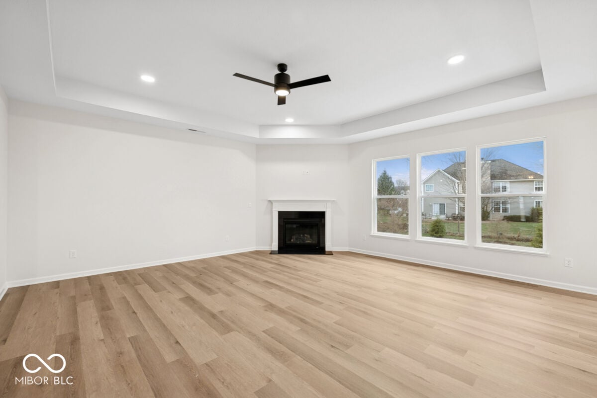 Bright modern living room with fireplace and hardwood floors.
