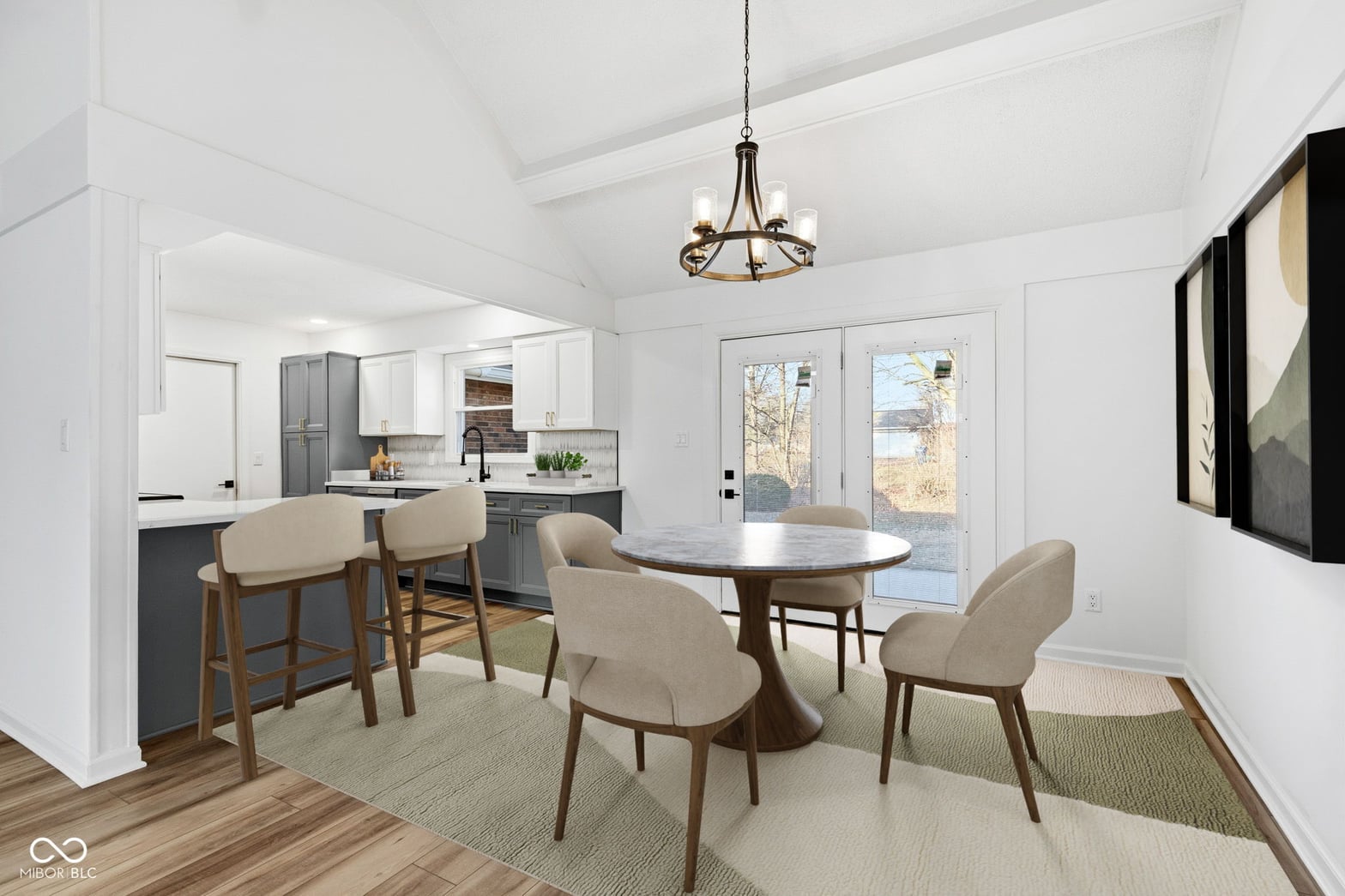 Bright open-concept dining with vaulted ceilings and garden views.