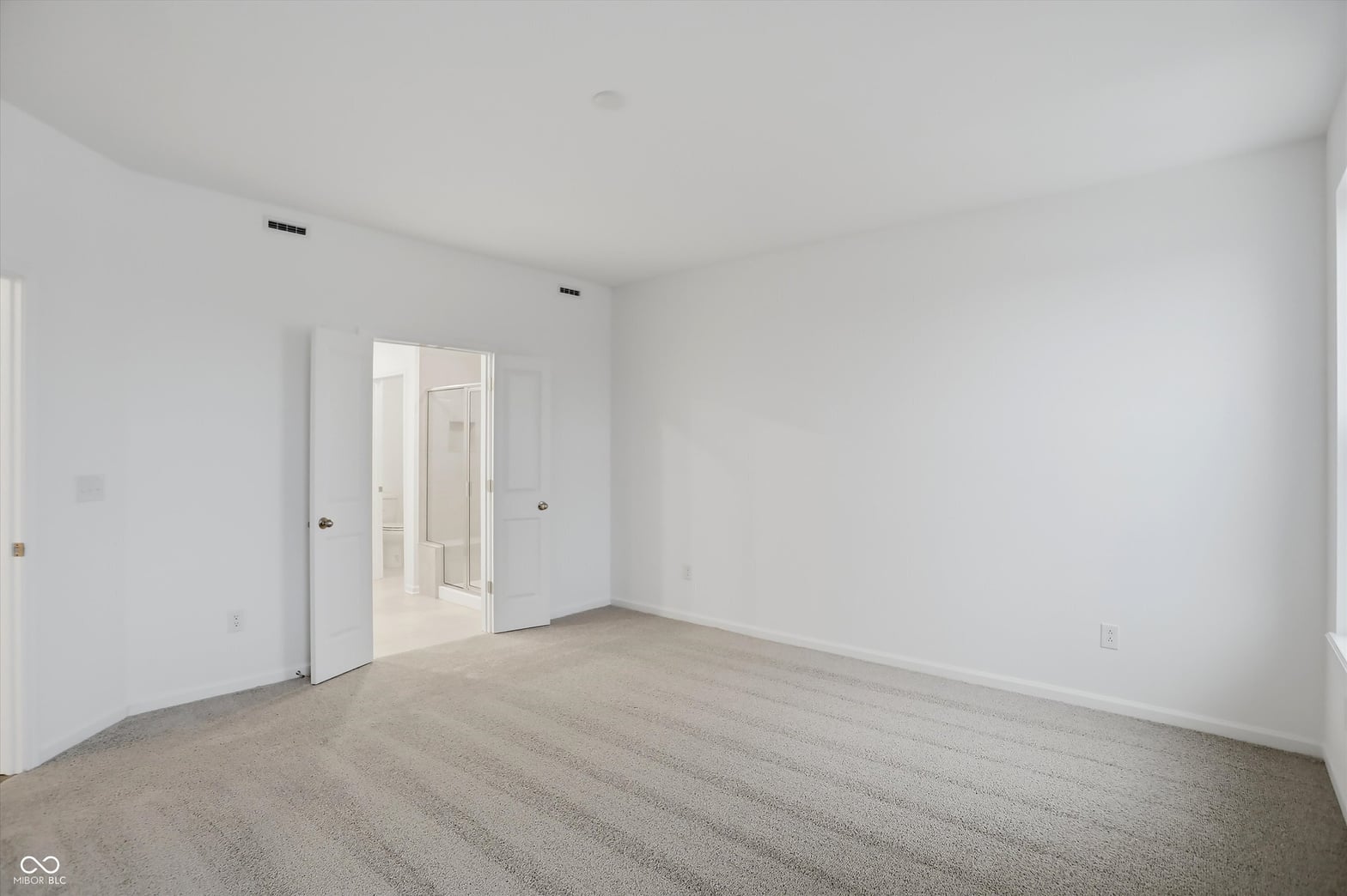 Spacious primary bedroom with ensuite bathroom access.