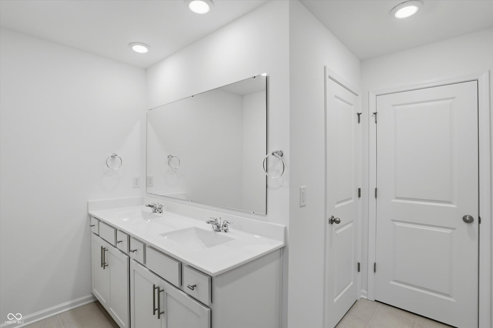 Spa-like primary bath with dual vanity and modern finishes.