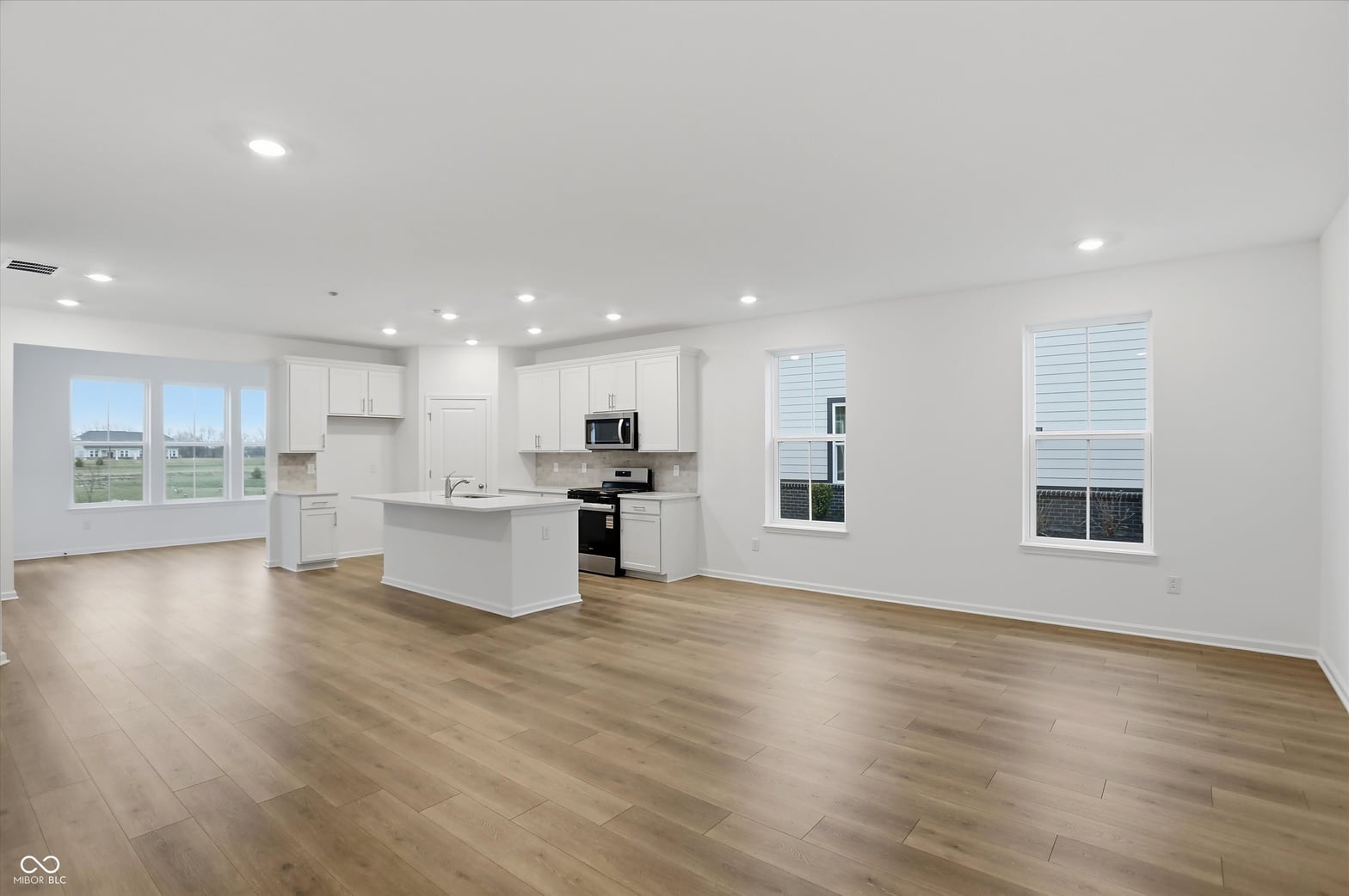 Bright modern kitchen with island and panoramic views.
