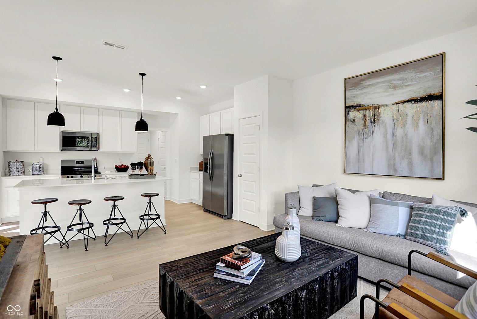 Bright open concept with modern kitchen and living areas.