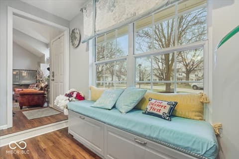 Living room at 7533 Castleton Farms North Drive, Indianapolis, IN — Bright bay window with custom built-in window seat.