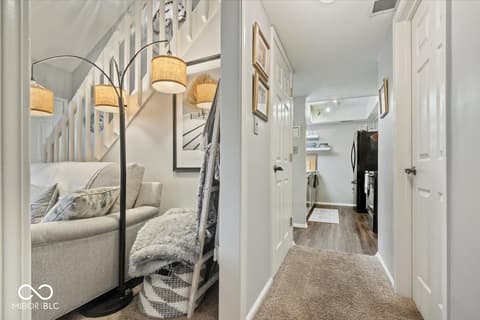 Hallway at 7533 Castleton Farms North Drive, Indianapolis, IN — Bright hallway with loft access and modern finishes.