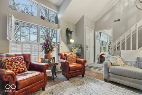 Living room at 7533 Castleton Farms North Drive, Indianapolis, IN — Bright, airy living room with soaring vaulted ceilings.