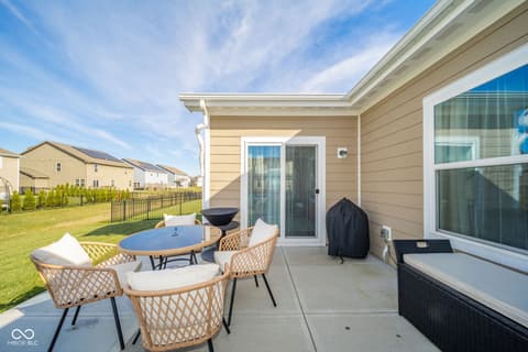 Outdoor living area at 16592 Branham Drive, Fishers, IN — Spacious patio with modern furnishings and fenced yard.
