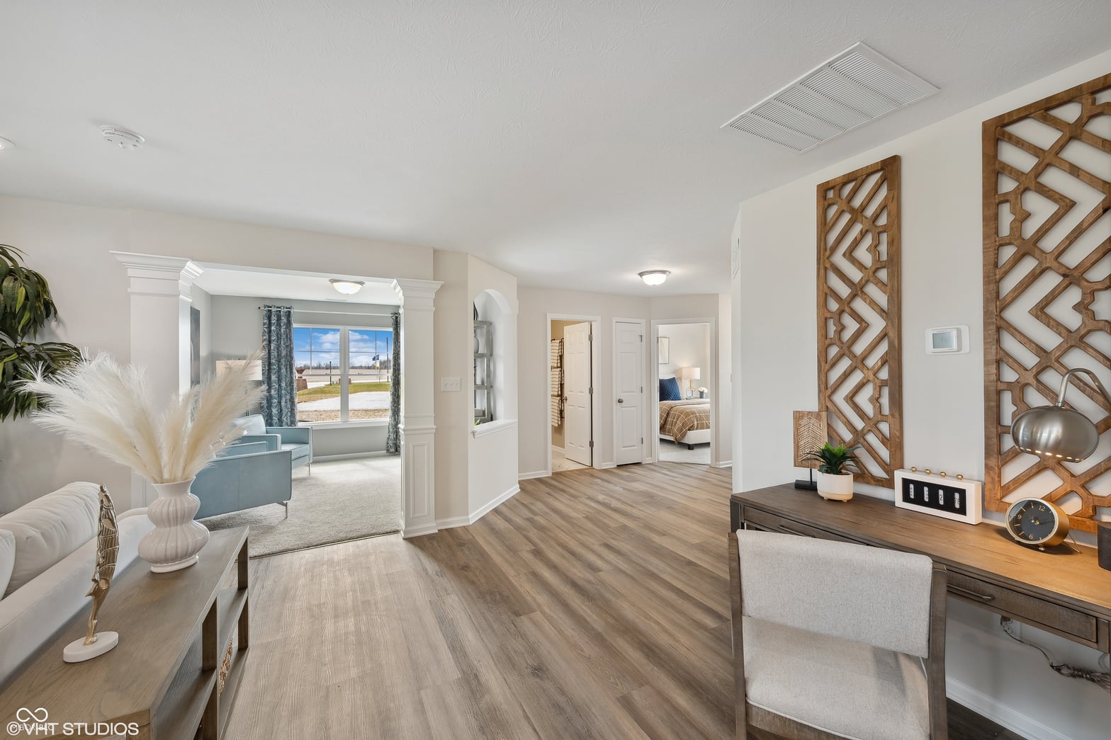 Spacious primary suite with panoramic water views and sitting area.