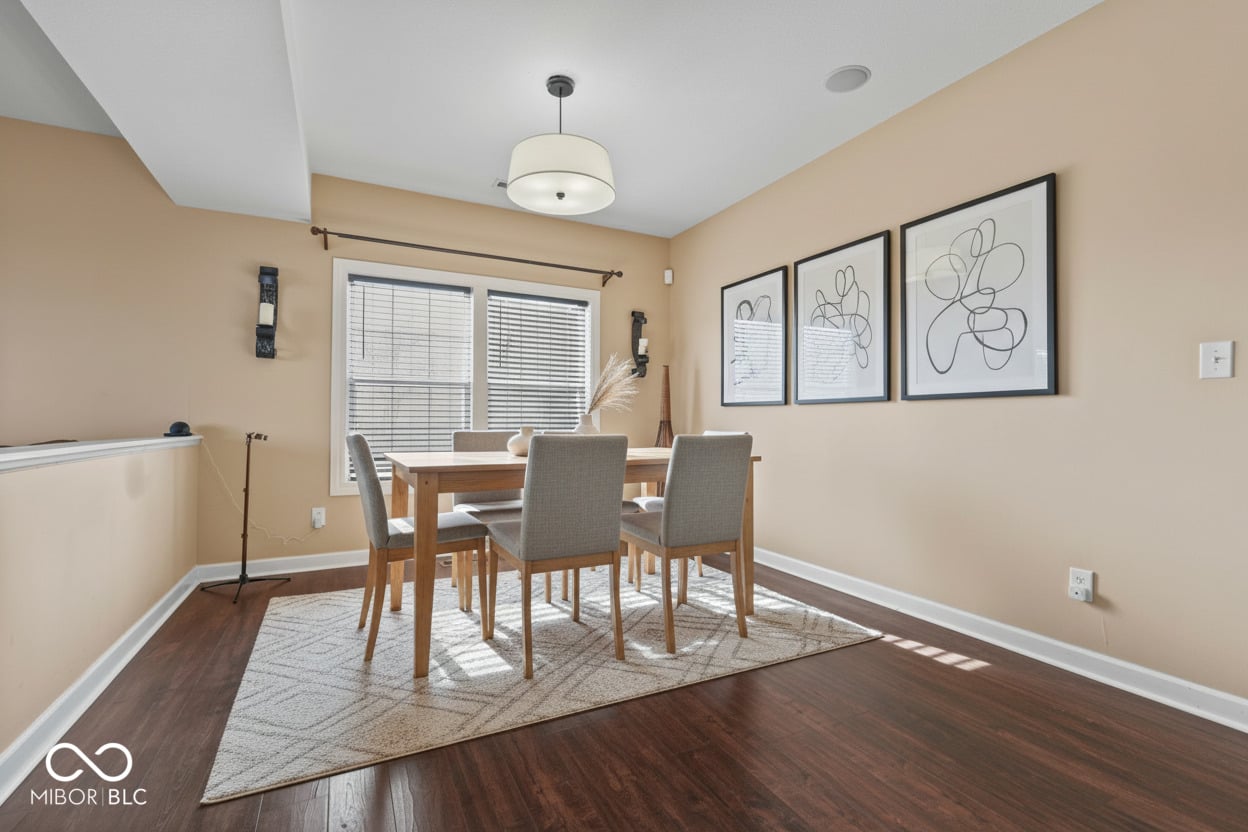 Bright dining room with hardwood floors and abundant natural light
