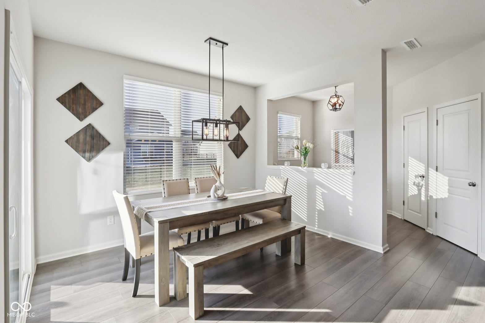 Bright farmhouse dining with hardwood floors and abundant natural light.