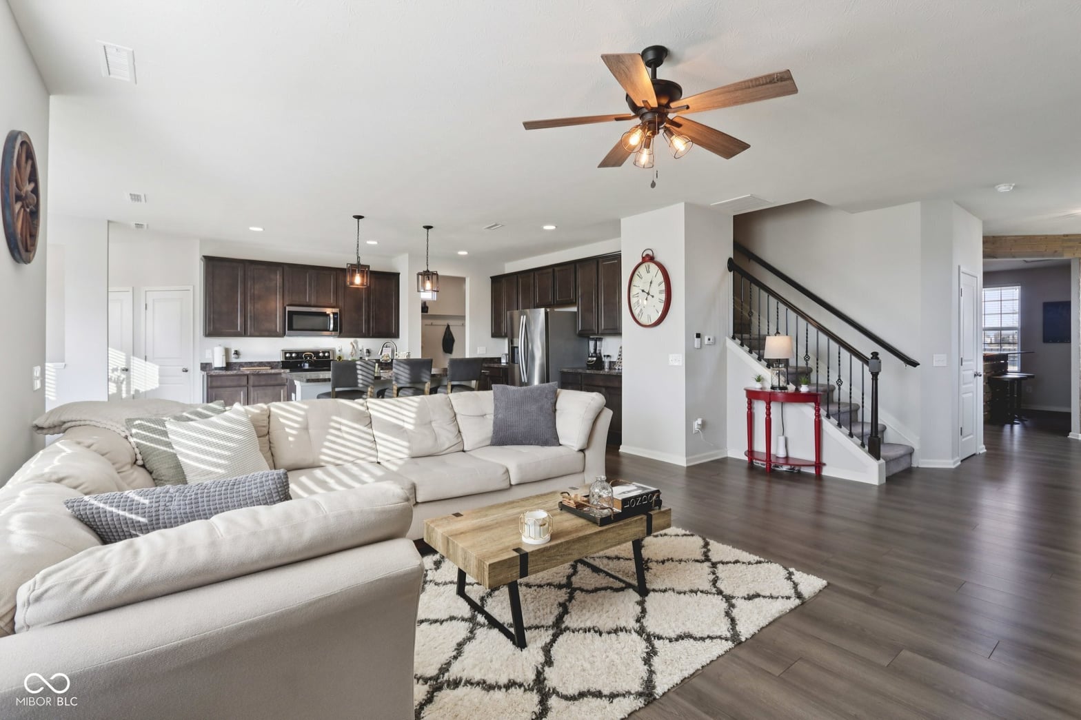 Spacious open concept with modern finishes and dark wood kitchen.