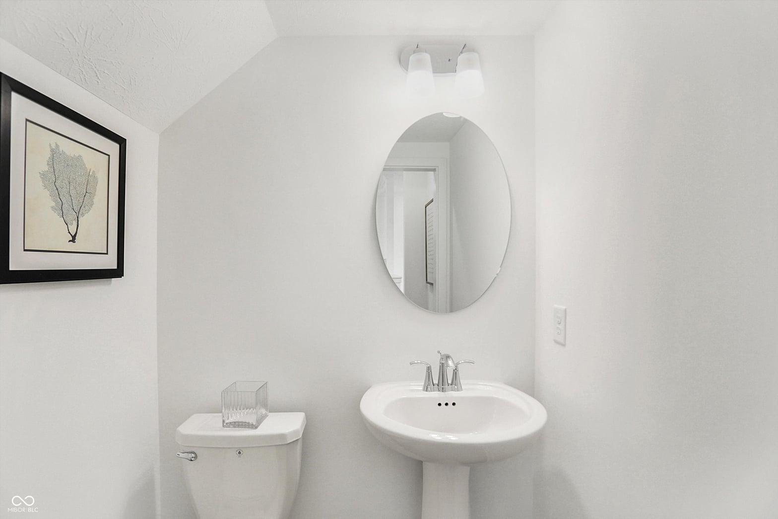 Clean, bright bathroom with modern pedestal sink setup.