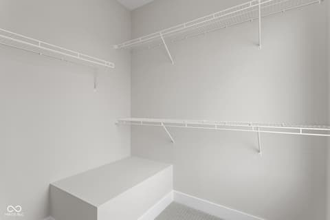 Primary bedroom at 449 Shade Street, Carmel, IN — Spacious walk-in closet with ample storage shelving.