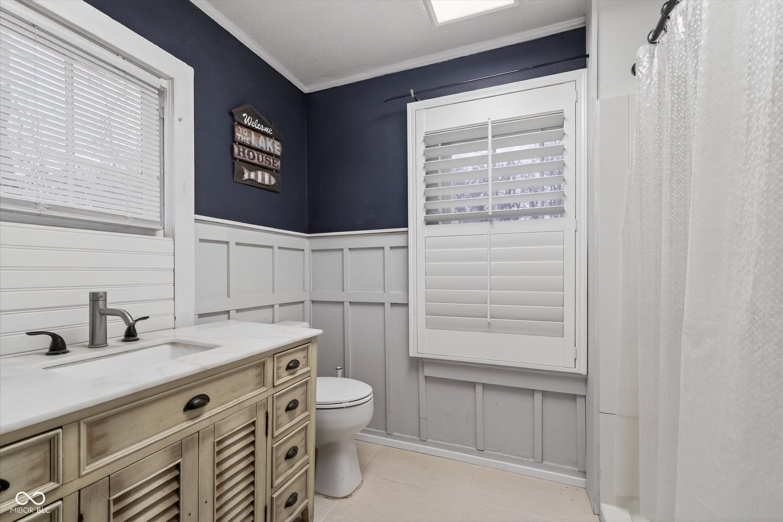 Spa-like primary bath with double vanity and custom finishes.