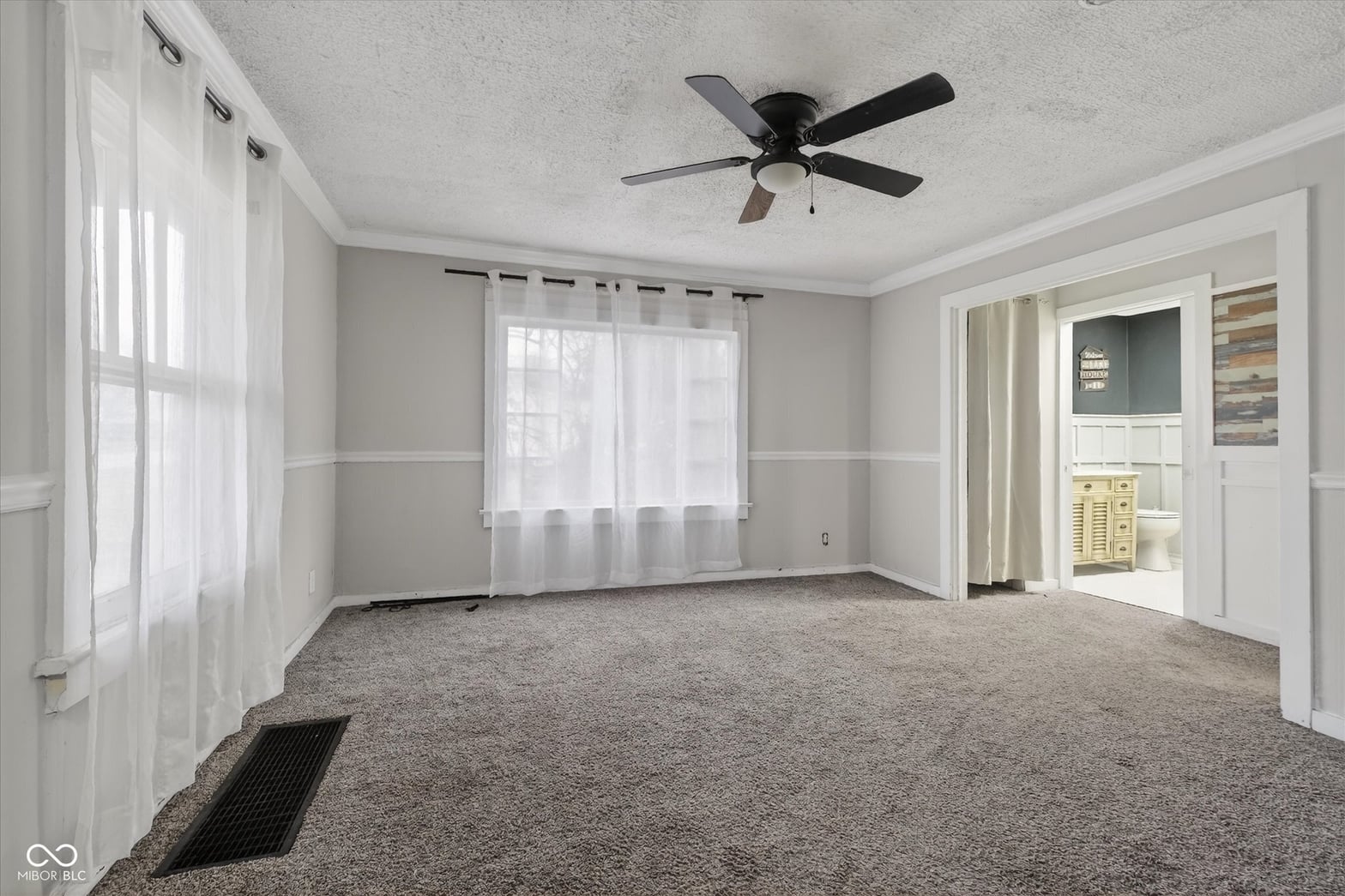 Bright, spacious living area with glass doors and neutral décor.