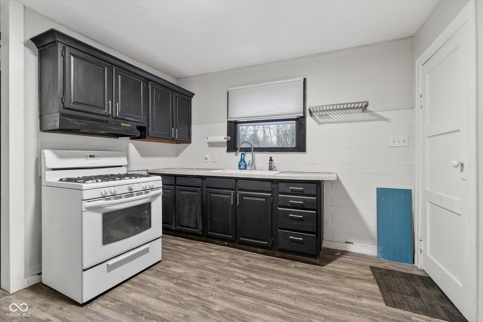 Updated kitchen with black cabinetry and modern finishes.