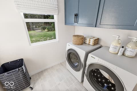 Laundry room at 9894 Cassia Drive, Carmel, IN — Bright, modern laundry room with dual appliances.