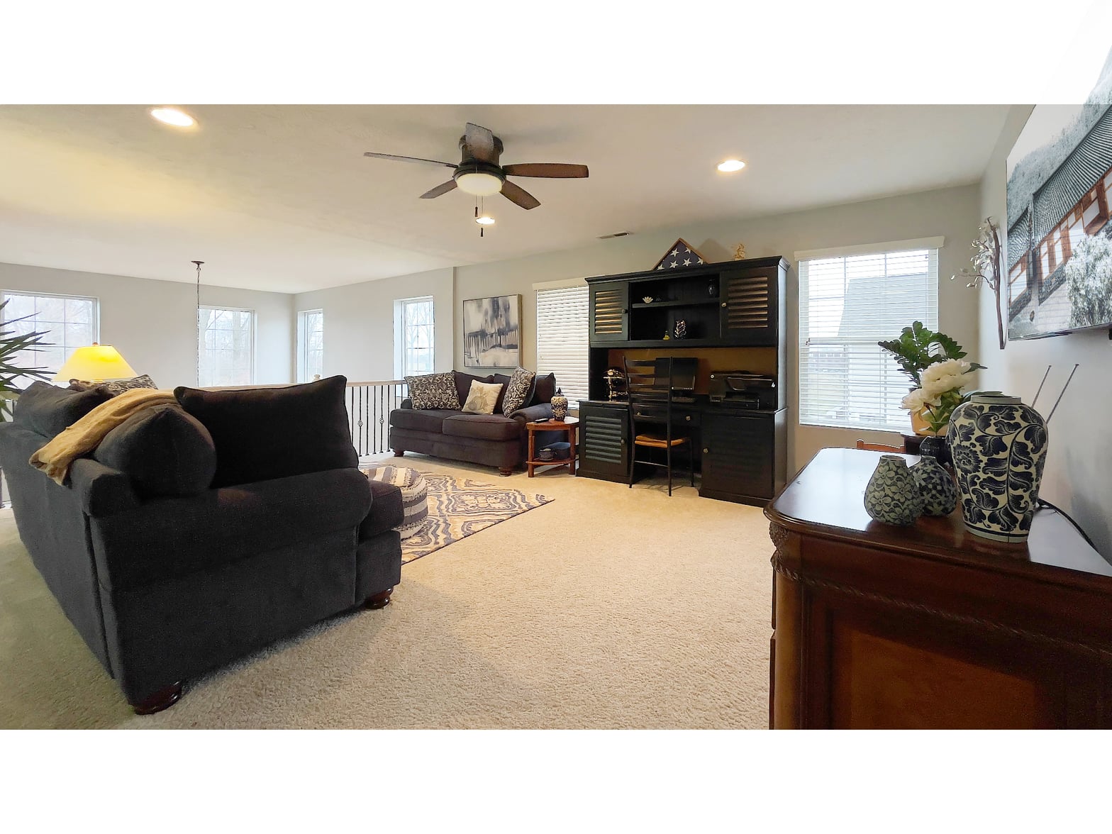 Spacious family room with built-in entertainment and ample natural light.