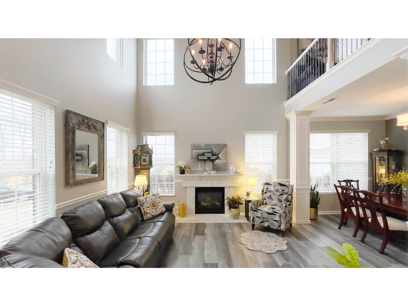 Bright two-story living space with modern fireplace and high-end finishes.