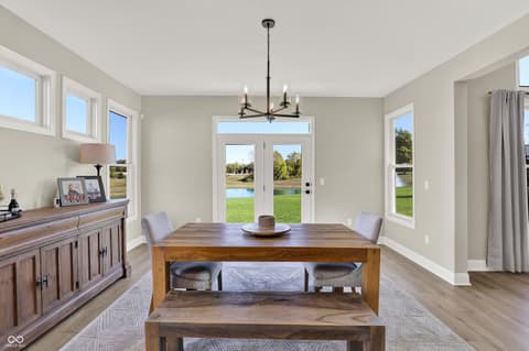 Dining room at 1560 Old Hickory Lane, Westfield, IN — Bright dining room with water views and french doors.