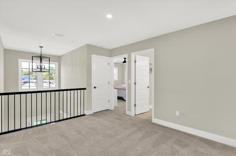 Hallway at 1560 Old Hickory Lane, Westfield, IN — Bright hallway with modern railing and neutral finishes.