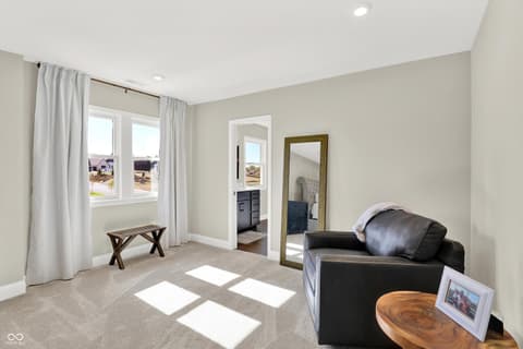 Primary bedroom at 1560 Old Hickory Lane, Westfield, IN — Bright primary suite with sitting area and ensuite access.