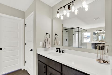 Primary bathroom at 1560 Old Hickory Lane, Westfield, IN — Luxurious primary bath with double vanity and glass shower.