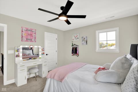 Bedroom at 1560 Old Hickory Lane, Westfield, IN — Bright bedroom with built-in vanity and modern ceiling fan.