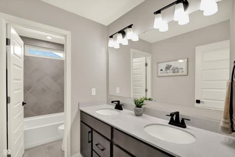 Primary bathroom at 1560 Old Hickory Lane, Westfield, IN — Spa-like primary bath with dual vanity and modern finishes.