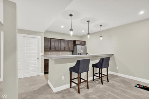 Kitchen at 1560 Old Hickory Lane, Westfield, IN — Modern kitchen with island seating and pendant lighting.