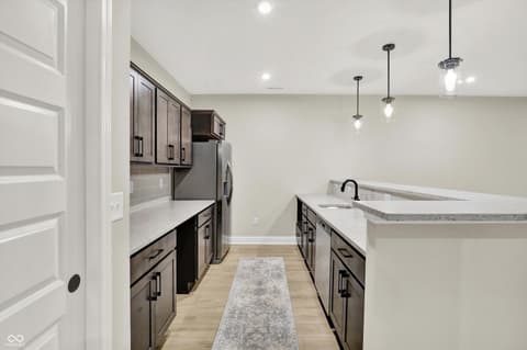 Kitchen at 1560 Old Hickory Lane, Westfield, IN — Modern kitchen with dark cabinetry and quartz counters.