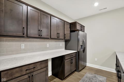 Kitchen at 1560 Old Hickory Lane, Westfield, IN — Modern kitchen with dark cabinetry and quartz counters.