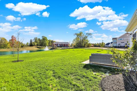 Yard at 1560 Old Hickory Lane, Westfield, IN — Spacious manicured yard with serene pond and fountain.