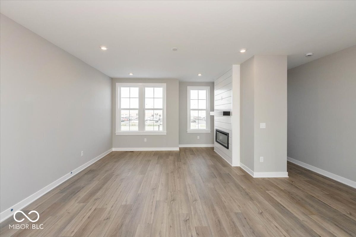 Bright, open living space with modern fireplace and large windows.