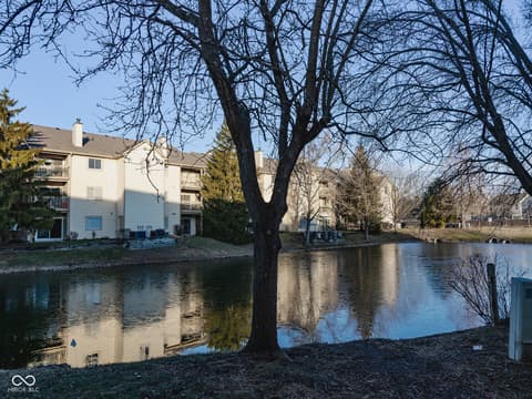 Backyard at 12517 Timber Creek Drive, Carmel, IN — Waterfront living with serene pond views and mature trees.