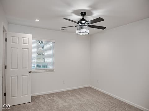 Bedroom at 12517 Timber Creek Drive, Carmel, IN — Bright bedroom with modern ceiling fan and natural light.