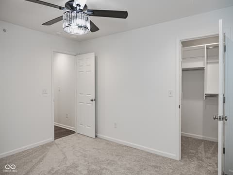 Primary bedroom at 12517 Timber Creek Drive, Carmel, IN — Spacious primary bedroom with dual walk-in closets.
