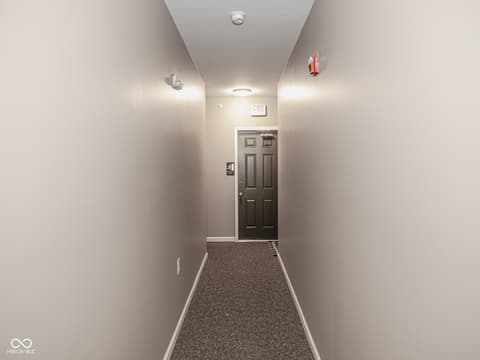 Hallway at 12517 Timber Creek Drive, Carmel, IN — Well-lit hallway with quality carpet and modern finishes.
