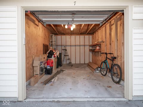 Garage at 12517 Timber Creek Drive, Carmel, IN — Spacious two-car garage with exposed framing and storage.