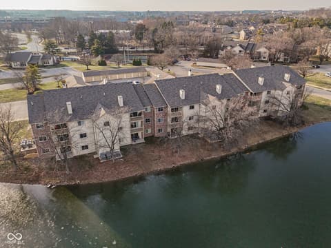 Aerial view at 12517 Timber Creek Drive, Carmel, IN — Riverfront multi-unit property with scenic water views.