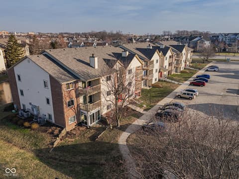 Front exterior at 12517 Timber Creek Drive, Carmel, IN — Well-maintained townhome community with convenient parking.