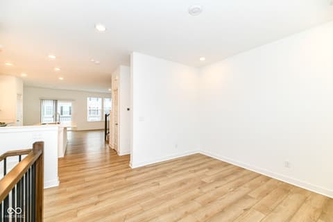 Family room at 6959 Equality Boulevard, Carmel, IN — Bright open concept with gleaming hardwood floors.