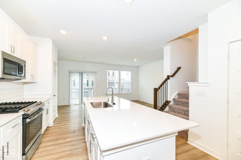 Kitchen at 6959 Equality Boulevard, Carmel, IN — Modern kitchen with island and open living connection.