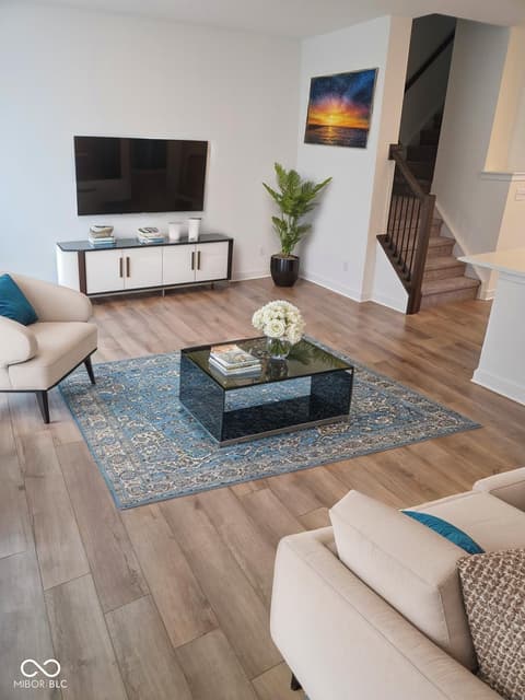 Living room at 6959 Equality Boulevard, Carmel, IN — Modern living room with hardwood floors and clean design.