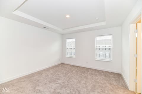 Bedroom at 6959 Equality Boulevard, Carmel, IN — Bright bedroom with elegant tray ceiling and natural light.