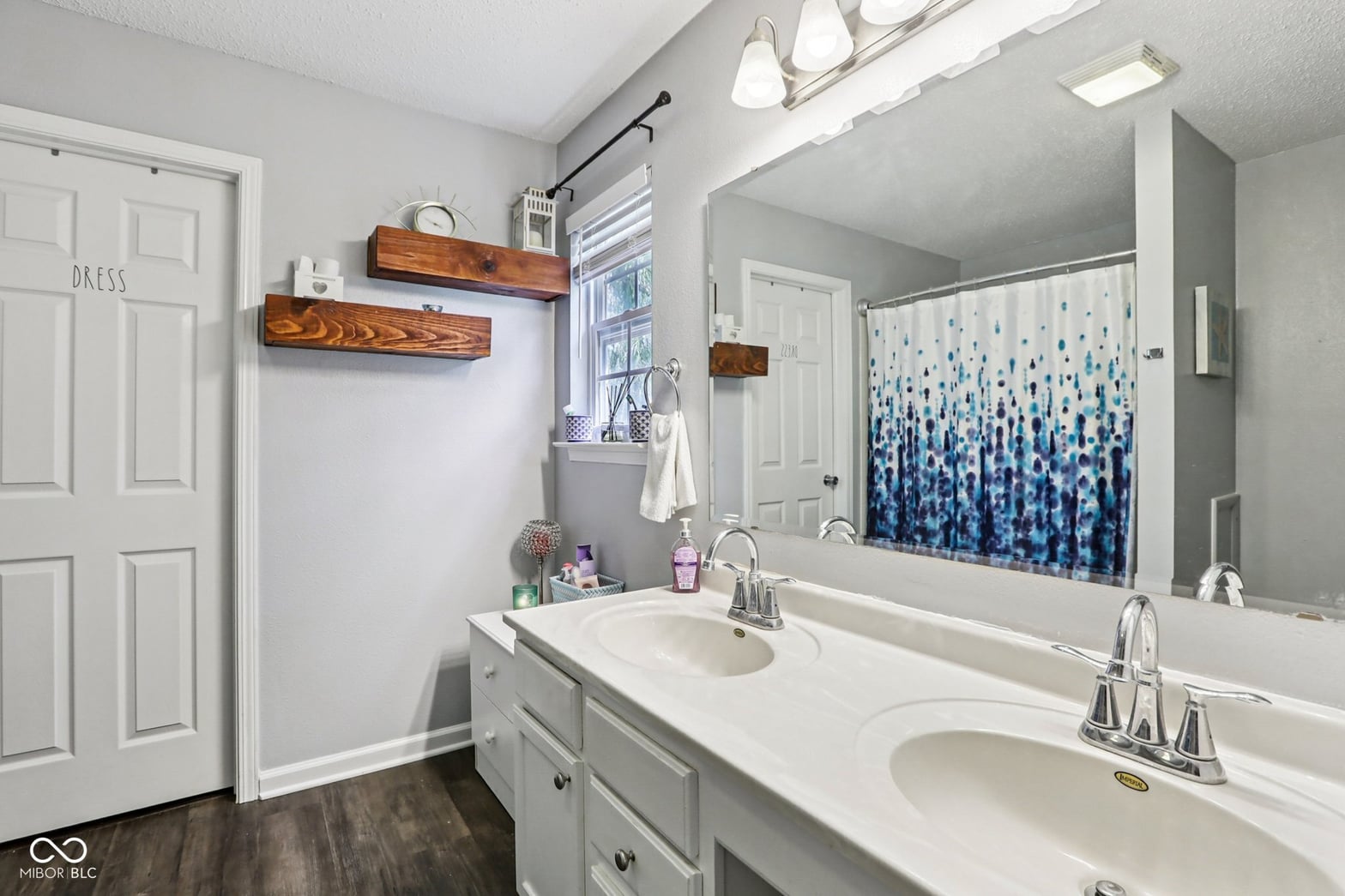 Bright primary bath with dual vanity and walk-in shower.